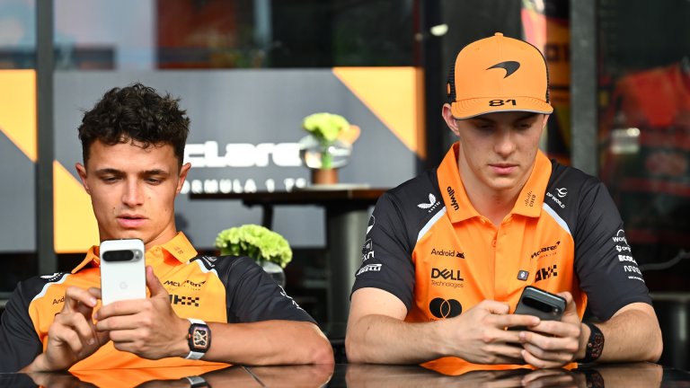 JEDDAH, SAUDI ARABIA - APRIL 17: Lando Norris of Great Britain and McLaren and Oscar Piastri of Australia and McLaren on their phones during previews ahead of the F1 Grand Prix of Saudi Arabia at Jeddah Corniche Circuit on April 17, 2025 in Jeddah, Saudi Arabia. (Photo by Mark Sutton - Formula 1/Formula 1 via Getty Images)